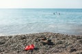 Shoes children's and adult stands on shore sea Royalty Free Stock Photo