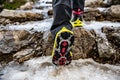 Shoes with crampons on the mountain trail in winter, climbing, adventure.