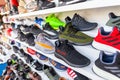 Shoes of different brands stands in a shop Royalty Free Stock Photo