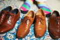 Shoes for every occasion. a man in colourful socks standing behind 3 pairs of leather loafers. Royalty Free Stock Photo