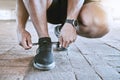 Shoes, fitness and exercise with a sports man tying his laces for a cardio and endurance workout in the city. Training Royalty Free Stock Photo