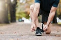 Shoes, fitness and runner with a sports man tying his laces before a run in the park for exercise. Running, training and Royalty Free Stock Photo