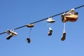 Shoes hanging on cable Royalty Free Stock Photo