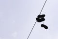 Shoes hanging on light wire
