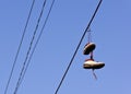 Shoes dangling from power line Royalty Free Stock Photo