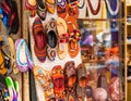 Shoes hanging on the wall in the workshop of the shoe maker, Puttaparthi, India Royalty Free Stock Photo