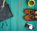 shoes, jeans, camera, watch and vintage keys on the blue wooden