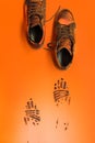 Shoes leaving black marks on an orange background