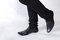 Shoes and legs of a businessman caution step