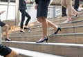 shoes legs of businesswoman walking stepping up-down stair in modern city hurry time, People walk rush hour to work in Royalty Free Stock Photo