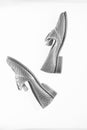 Shoes made out of silver leather on white background, isolated. Female footwear concept. Footwear for women on flat sole