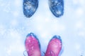 Shoes for men and women facing each other winter snow.