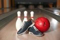 Shoes, pins and ball on bowling lane in club Royalty Free Stock Photo