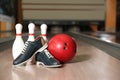 Shoes, pins and ball on bowling lane in club Royalty Free Stock Photo