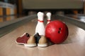 Shoes, pins and ball on bowling lane in club Royalty Free Stock Photo