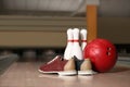 Shoes, pins and ball on bowling lane Royalty Free Stock Photo