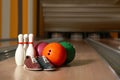 Shoes, pins and balls on bowling lane in club Royalty Free Stock Photo