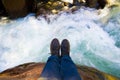 Shoes with a river as background Royalty Free Stock Photo