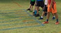 Shoes of runners on start point for run grass track