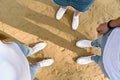 Shoes selfie from above. Teenagers stand on sand in white sneakers. Top view Royalty Free Stock Photo