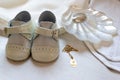 Shoes, shell and white baby suit, with a gold medal