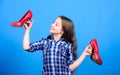 Shoes shop. Happy childhood. Glamour high heels. Awesome red stiletto shoes. Little fashionista kid with high heels Royalty Free Stock Photo