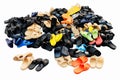 Piles of shoes sold in various color combinations rural land market, sandals, casual shoes, old. on white background