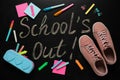 Shoes, stationery and text SCHOOL`S OUT written on blackboard, flat lay. Summer holidays Royalty Free Stock Photo