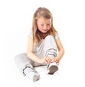 Shoes tie, kid and casual fashion with sneakers and youth with modern clothing in studio. Sitting, ground and young girl