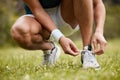Shoes, tie and a sports person getting ready for an exercise run closeup outdoor for cardio training. Fitness, hands or