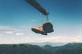 Shoes trekking boots hanging over mountains Royalty Free Stock Photo