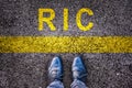 Shoes and word RIC meaning referendum at citizen`s initiative on asphalt