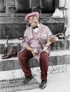 Shoeshine man working and smiling Royalty Free Stock Photo