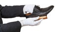 Shoeshiner in white gloves brushing black shoe Royalty Free Stock Photo