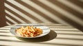 Shoestring fries are thin, crispy French fries that are cut into matchstick-like strips. Dramatic Shadow play.