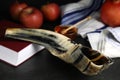 Shofar and Torah on black table, closeup. Rosh Hashanah celebration