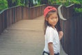 Shoot Asian cute little girl standing on wooden walway and feeling happiness.