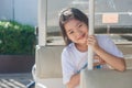 Shoot Asian little cute girl siting in golf car and smiling.