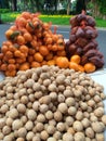 Shoot on fresh fruits selling on street market & x28; orange citrus, snake fruit or salak, duku fruit & x29;