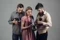 Shoot smart school. Retro style woman and men hold analog photo cameras. Paparazzi or photojournalists with vintage old