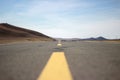 Shoot a tarmac road to the foot of the mountain from a low angle Royalty Free Stock Photo