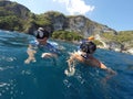 Shoot of a young boy snorkeling with father Royalty Free Stock Photo