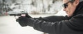 Shooter holding gun and training tactical shooting. Close-up detail view