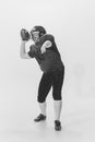 Black and white portrait of american football player in vintage style sports uniform isolated on white background Royalty Free Stock Photo