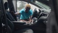 Shooting from car of African American man in wheelchair entering vehicle in slow motion. Handsome young ill guy fighting