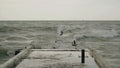 Shooting of the choppy sea near the berths on the shore.