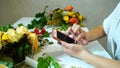 Close-up of smartphone and hands of female florist who drives Royalty Free Stock Photo