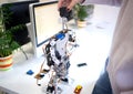 shooting close-up. woman designs a large modern robot