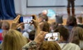 shooting a concert on a mobile phone blurred background of the scene and the audience Royalty Free Stock Photo