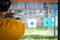 Shooting with Gun at Target in Shooting Range. Royalty Free Stock Photo